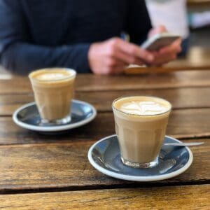 Two cups of coffee on a wooden table